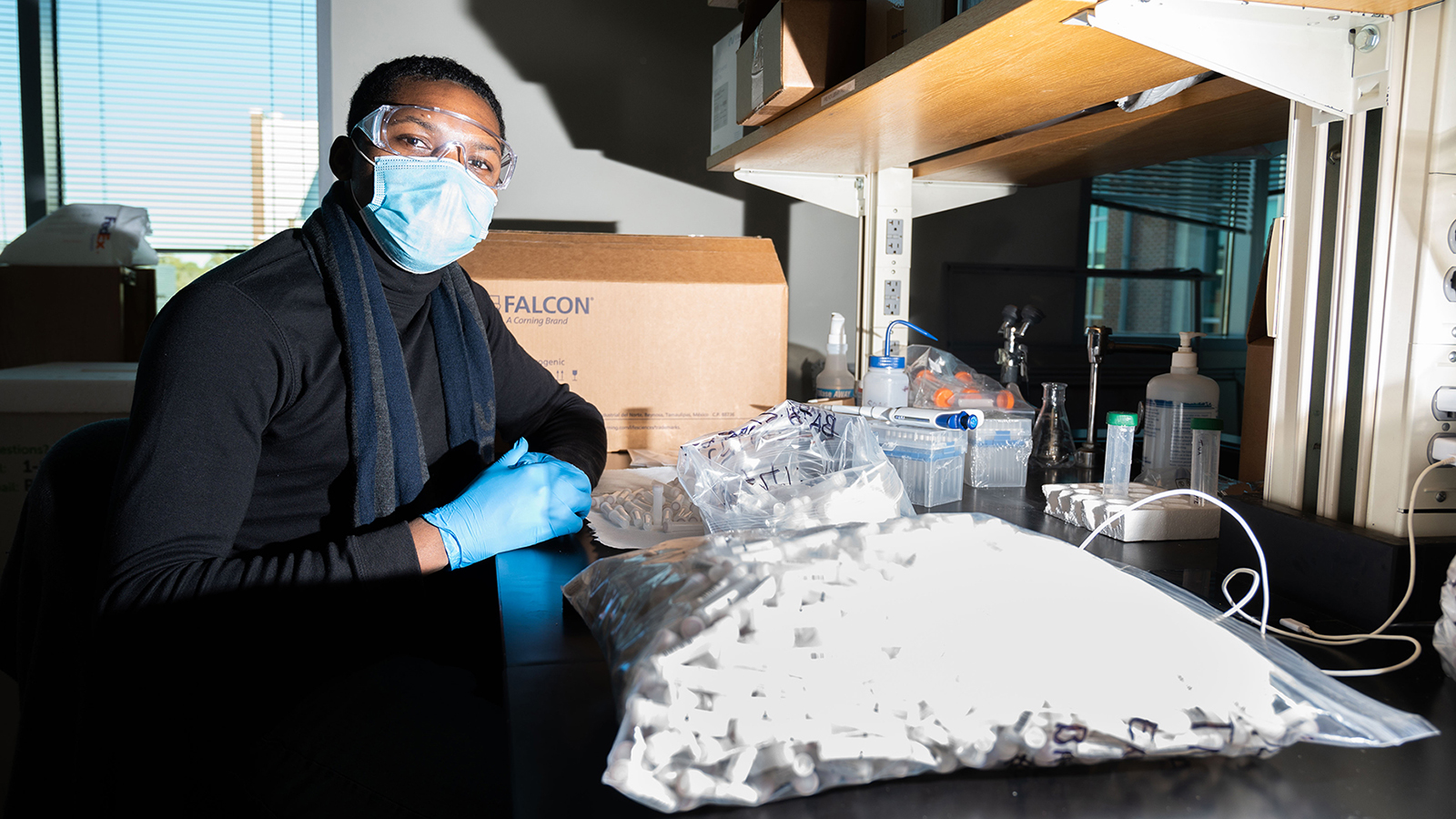 A staff member assembles kits for campus Covid-19 surveillance testing