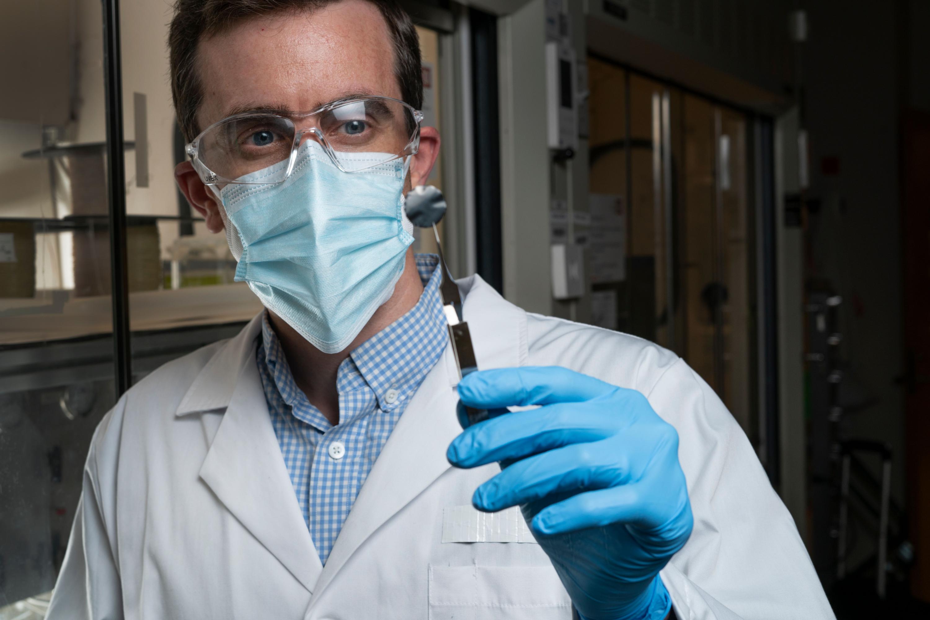 Georgia Tech Associate Professor Ryan Lively holding a small sample used to experimentally understand how the xylenes transport through the carbon structure. (Photo credit: Christopher Moore, Georgia Tech)