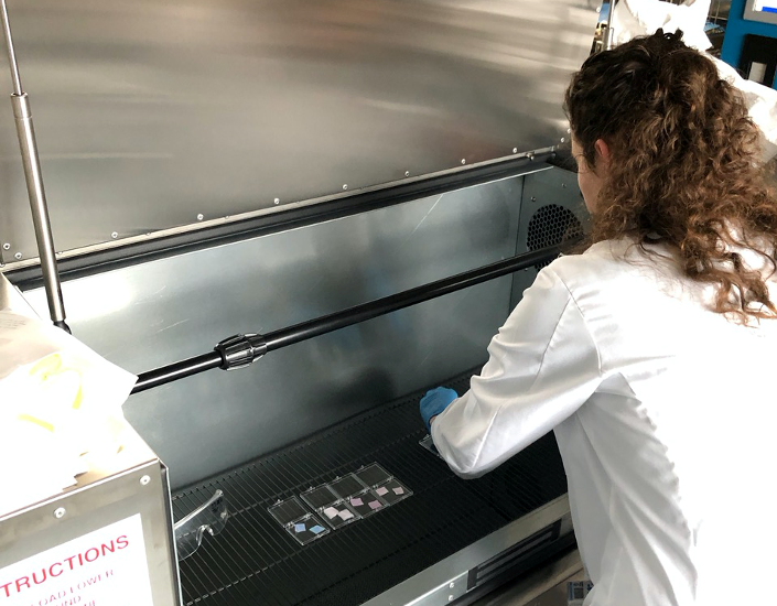 Researcher Emmeline Blanchard from the Wallace H. Coulter Department of Biomedical Engineering at Georgia Tech and Emory University places items into an ozone disinfection chamber for testing. (Photo: Georgia Tech)