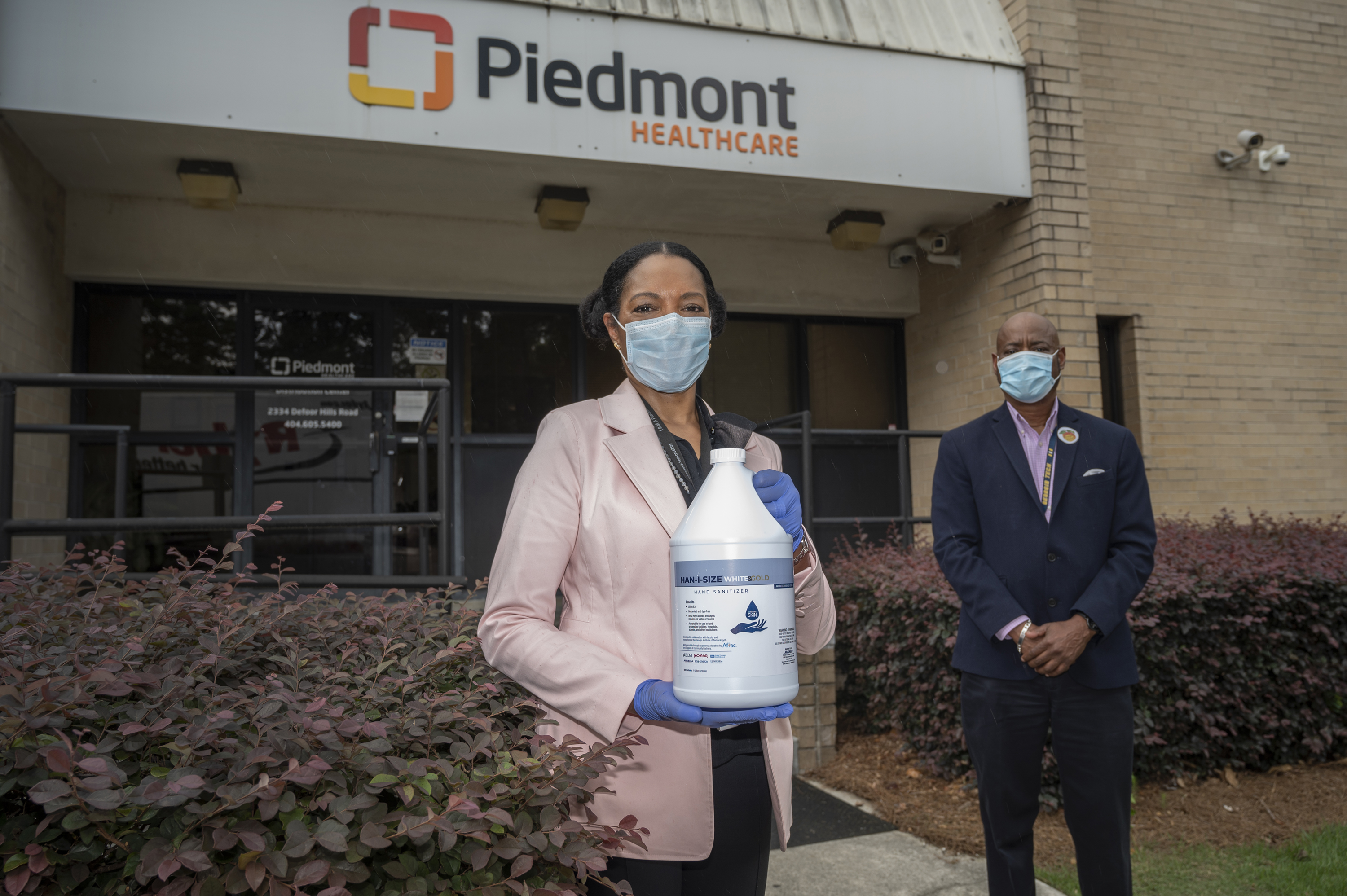 Dr. Jayne Morgan welcomes the first delivery of the newly designed, ethanol-based hand sanitizer to Piedmont Healthcare of Atlanta. Behind her, George White of Georgia Tech, a team member in the hand sanitizer initiative. Georgia Tech / Christopher Moore