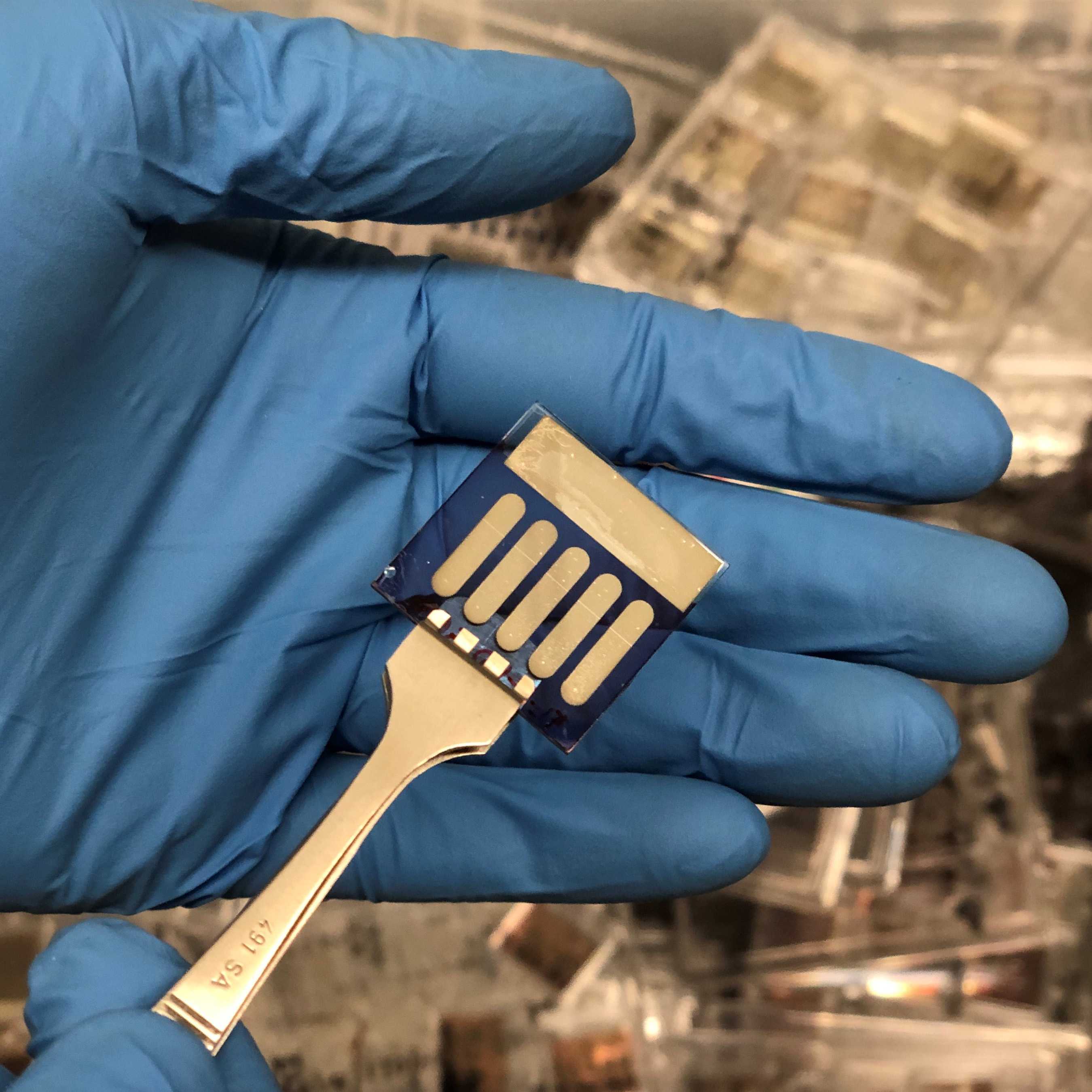 This sample includes five small area organic photovoltaic devices that were fabricated in the Kippelen Research Group at Georgia Tech. Samples with similar geometry were sent to the ISS to investigate the effects of exposure to space environments. (Photo: Bernard Kippelen, Georgia Tech)