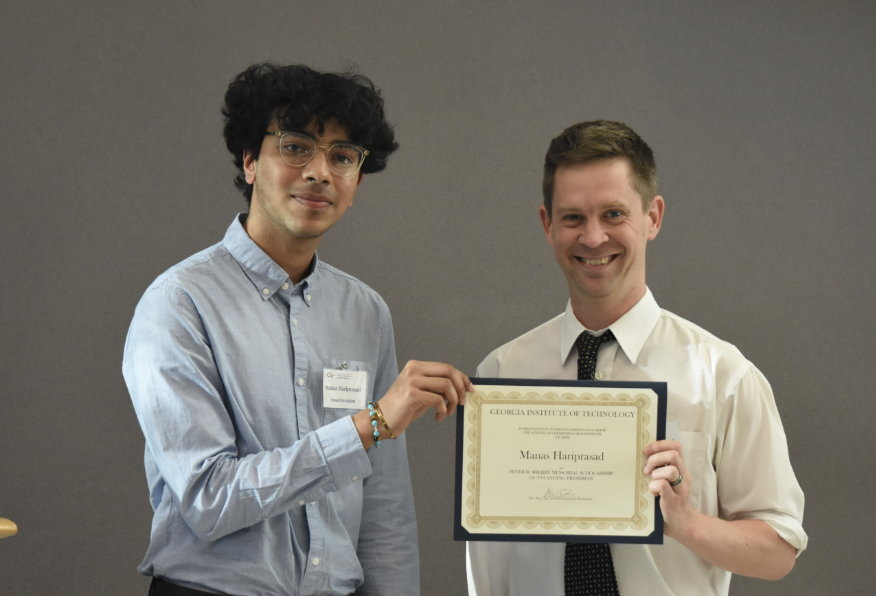 Student with Dr. Evans receiving an award.