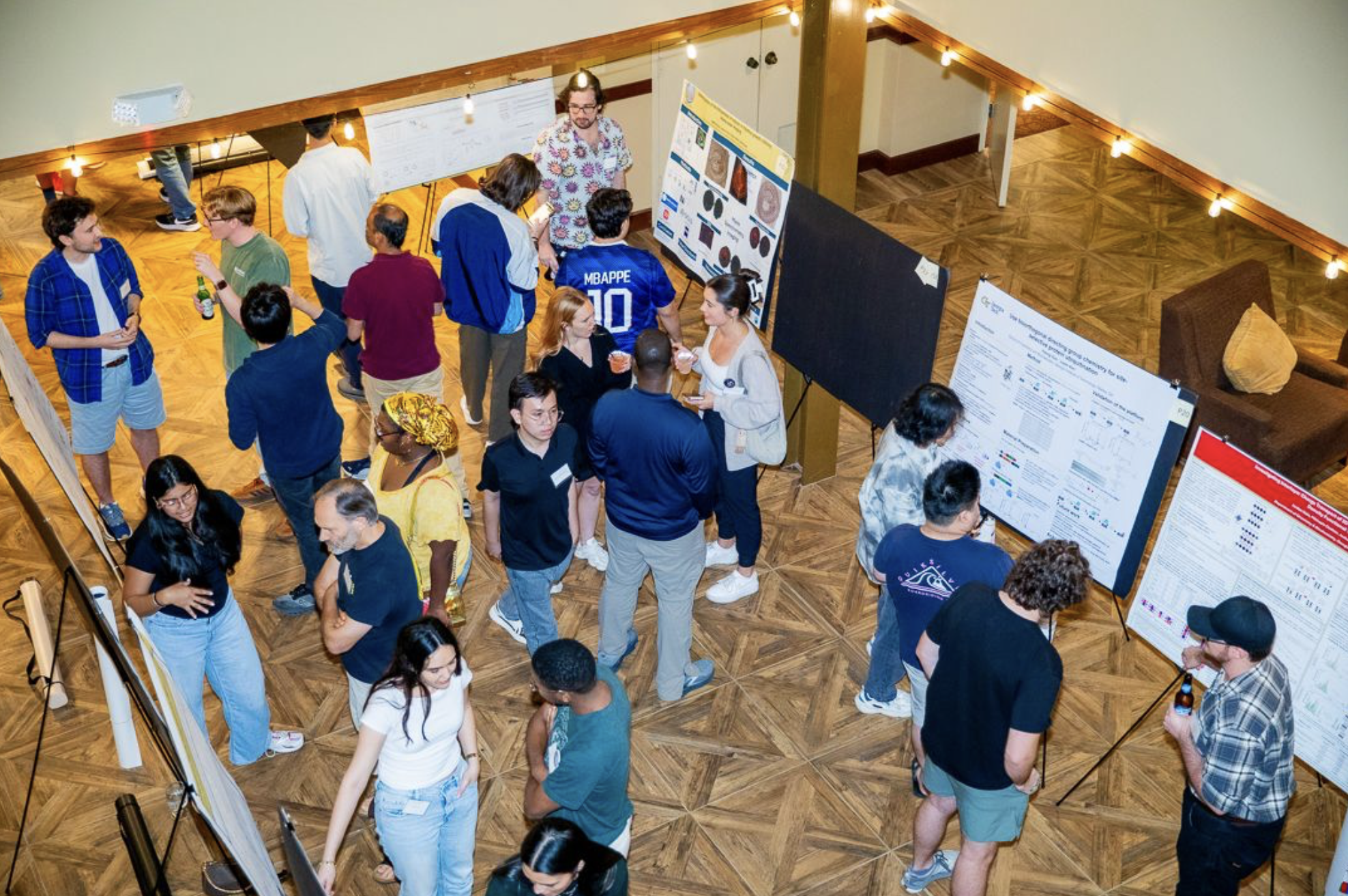 Students and faculty browsing research posters.